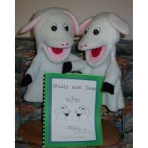 Two sheep puppets with lively expressions stand beside a green-covered booklet titled "Wooly and Sam," suggesting a storytelling or educational activity.